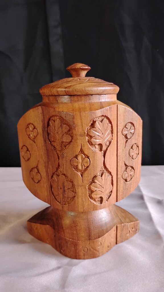 Wooden canister with engravings.